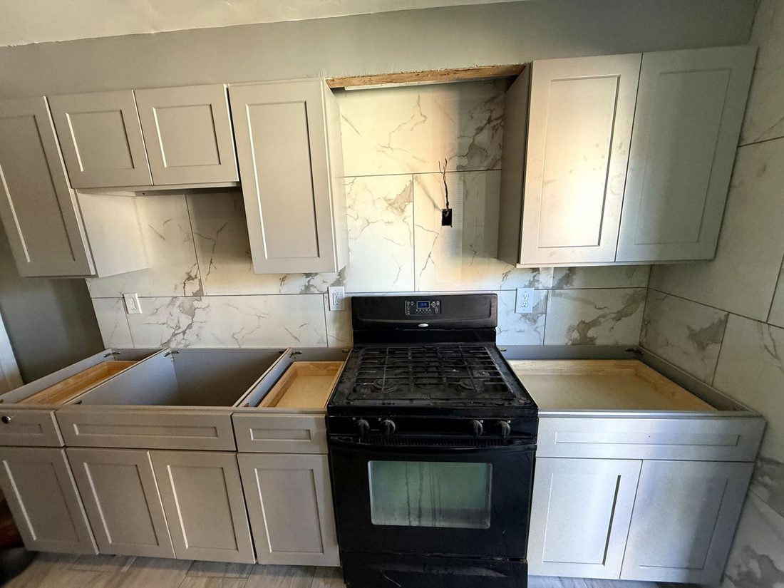 Grey shaker cabinets installed and leveled before countertops