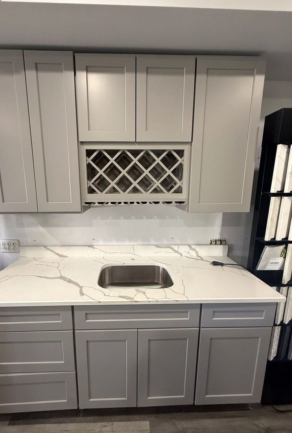 Grey shaker kitchen cabinets with a lattice wine rack