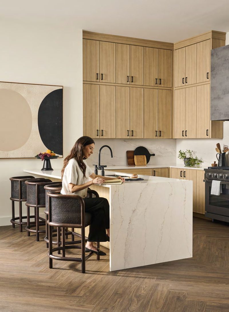 Light oak kitchen with a veined stone island