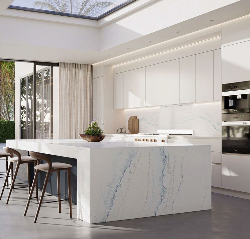 Bright white kitchen with a blue-veined waterfall island
